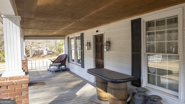 wooden terrace with a porch