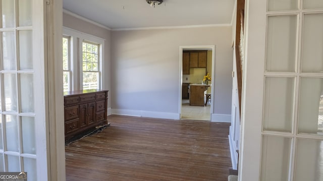 interior space with ornamental molding and dark hardwood / wood-style floors