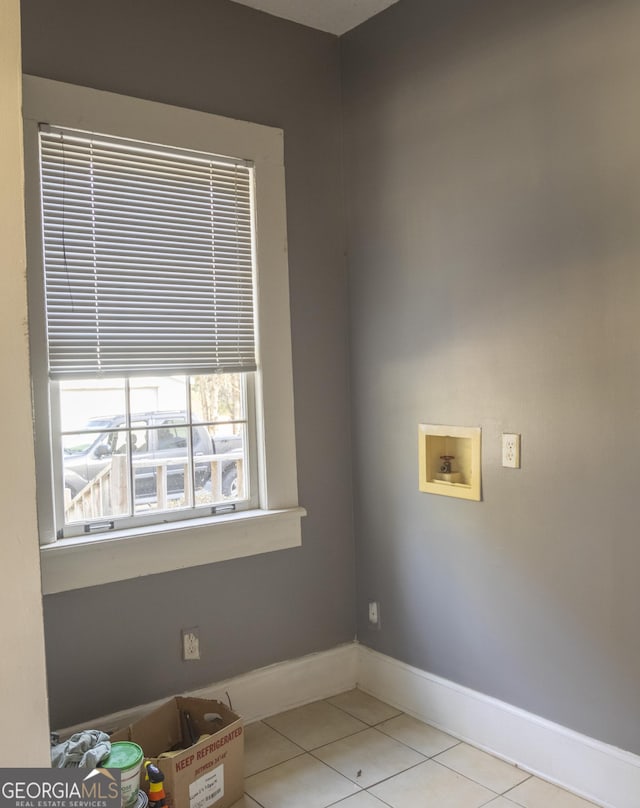 laundry room with washer hookup and light tile patterned floors