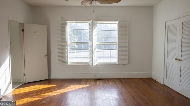 interior space with hardwood / wood-style flooring, ceiling fan, and a closet