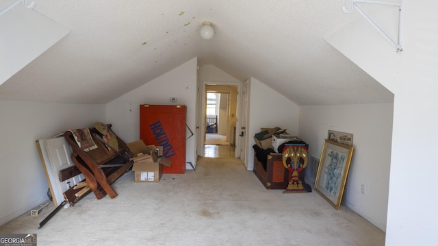 bonus room with vaulted ceiling and light carpet