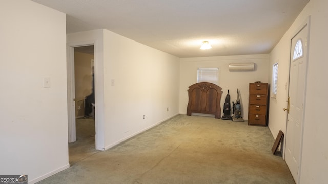 interior space featuring light carpet and a wall mounted air conditioner