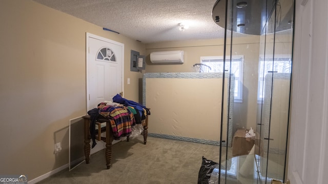 interior space with walk in shower, a wall mounted air conditioner, electric panel, and a textured ceiling