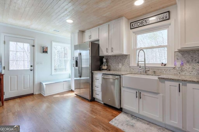 kitchen with sink, white cabinets, and appliances with stainless steel finishes