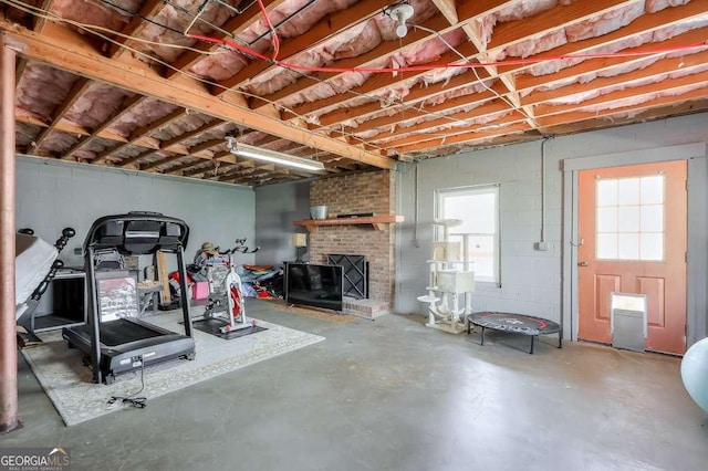 exercise area with a brick fireplace