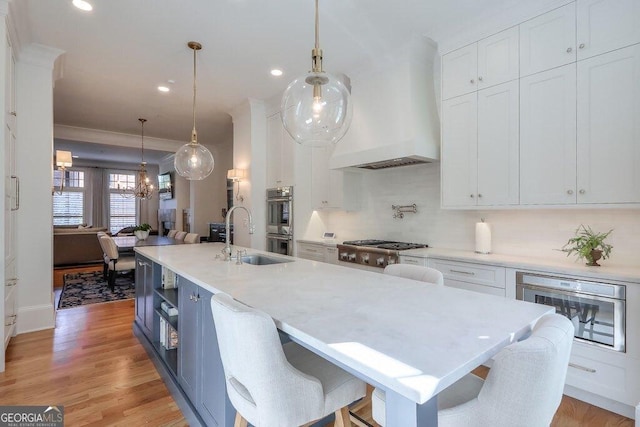 kitchen with white cabinetry, sink, and a breakfast bar