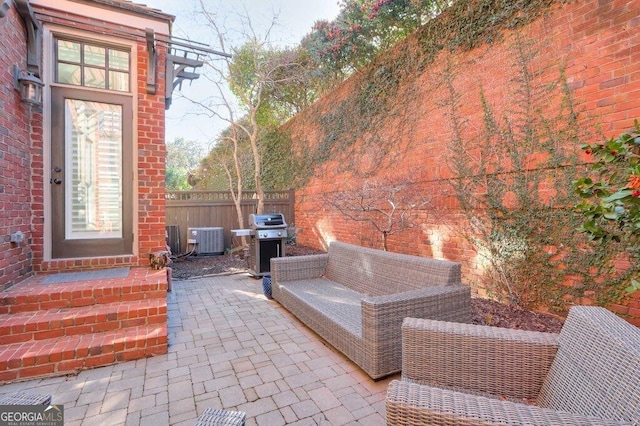 view of patio / terrace featuring an outdoor living space, central AC unit, and grilling area