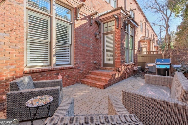 view of patio with an outdoor living space and a grill