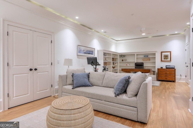 living room featuring ornamental molding and light wood-type flooring