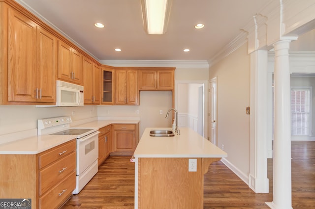 kitchen with sink, white appliances, a kitchen island with sink, decorative columns, and ornamental molding