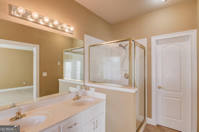 bathroom featuring an enclosed shower, vanity, and tile patterned floors