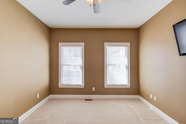 unfurnished room featuring ceiling fan and light colored carpet