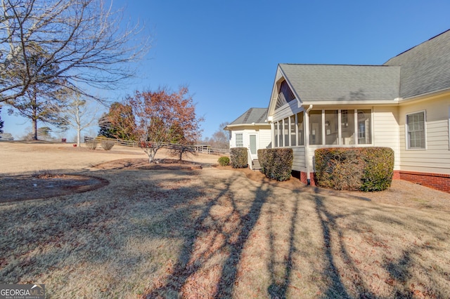 view of yard featuring a sunroom