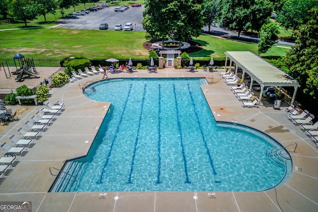 view of swimming pool with a yard and a patio area