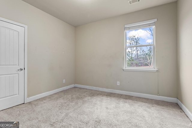 unfurnished room featuring light carpet