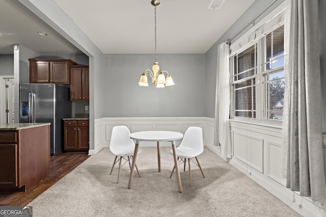 dining room featuring dark wood-type flooring and a notable chandelier