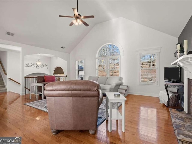 living room featuring ceiling fan, wood-type flooring, and high vaulted ceiling