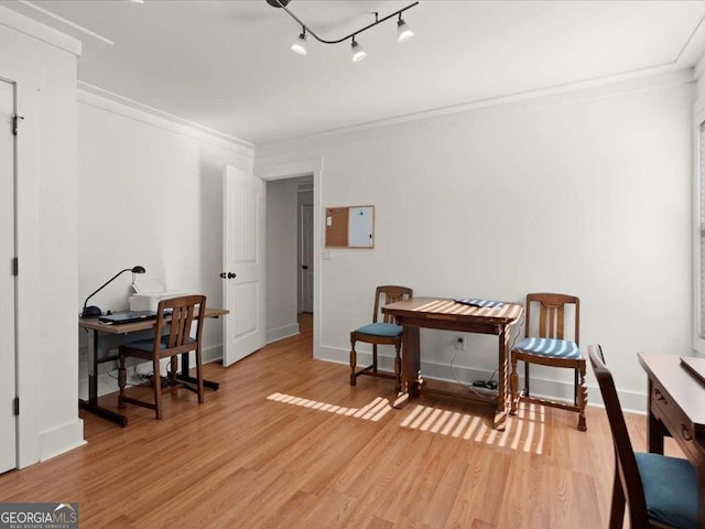 sitting room with crown molding and light hardwood / wood-style flooring