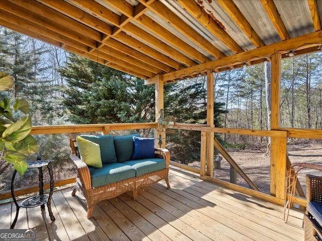 wooden terrace with an outdoor living space