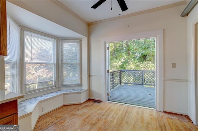 doorway featuring ornamental molding and light hardwood / wood-style flooring