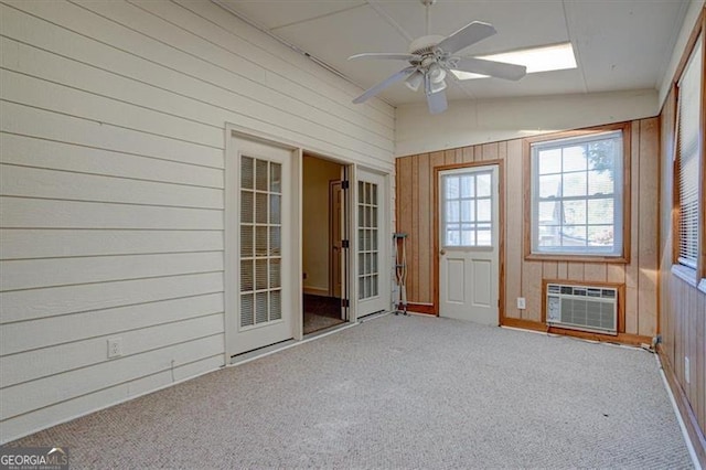 unfurnished sunroom with lofted ceiling, a wall mounted air conditioner, and ceiling fan