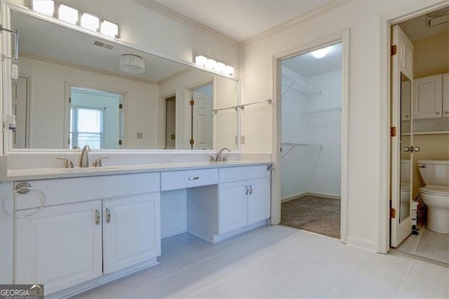 bathroom with vanity, crown molding, tile patterned floors, and toilet