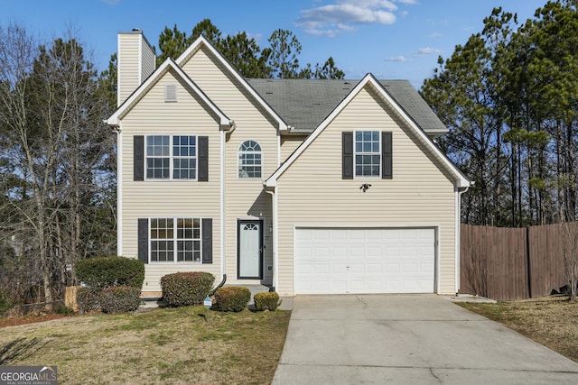 front facade with a garage and a front lawn