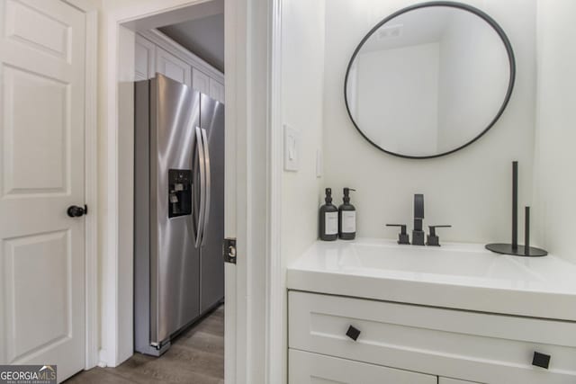 bathroom with vanity and wood-type flooring