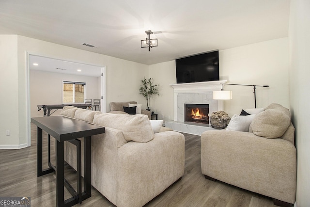 living room with wood-type flooring and a fireplace