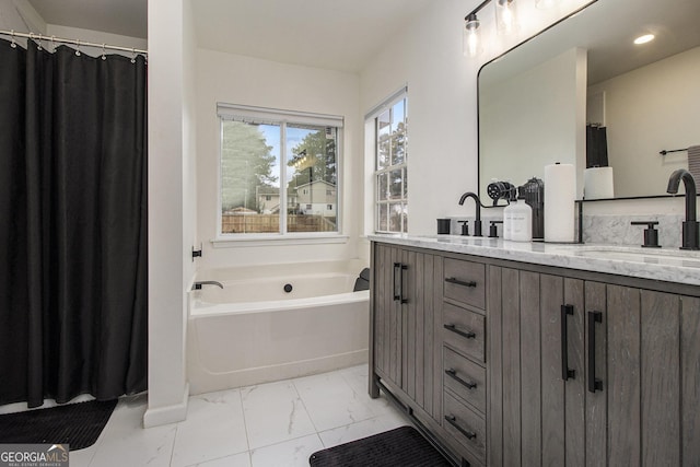 bathroom featuring vanity and a bath