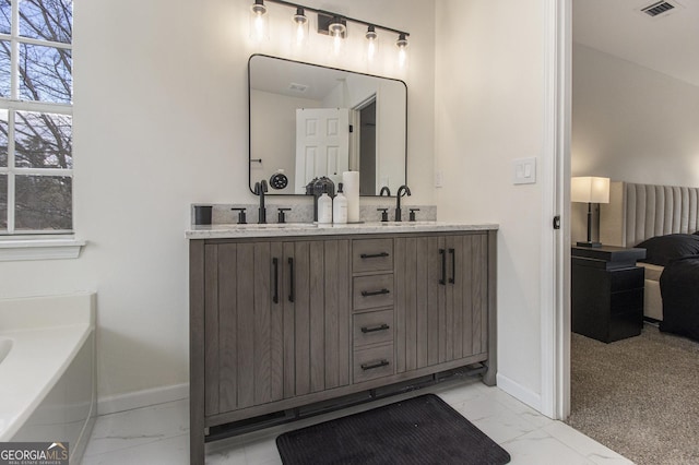 bathroom with a tub to relax in and vanity