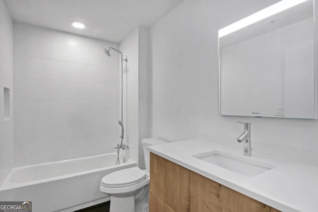 full bathroom featuring vanity, toilet, and tiled shower / bath combo