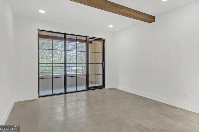 empty room featuring beam ceiling and concrete flooring