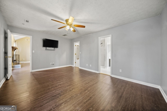 spare room featuring ceiling fan, dark hardwood / wood-style floors, and a textured ceiling