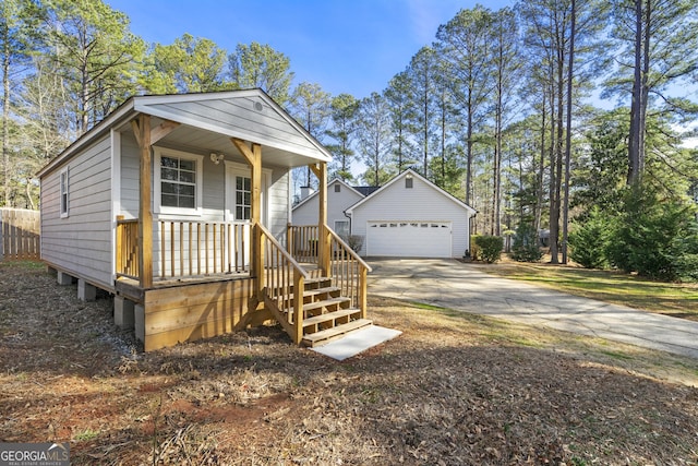 view of front of house with a garage and an outdoor structure