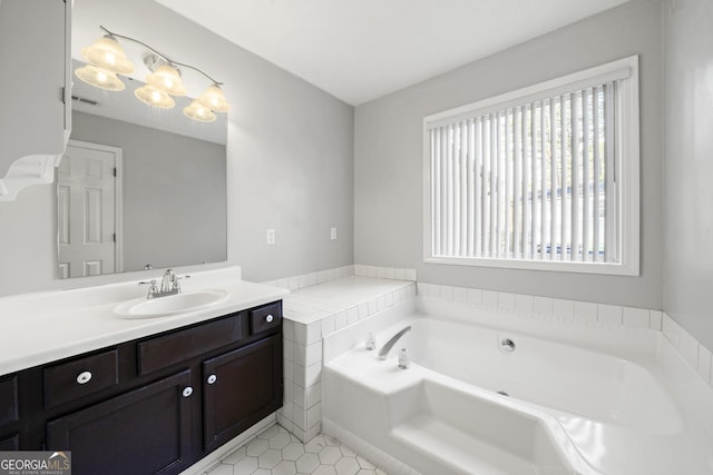 bathroom with vanity, a washtub, and tile patterned floors