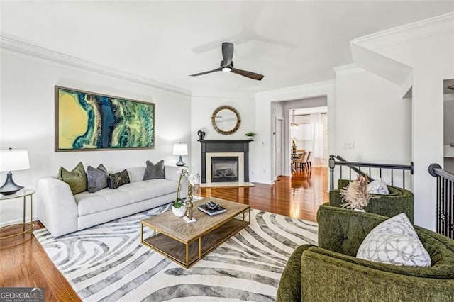 living room featuring crown molding, ceiling fan, and hardwood / wood-style flooring