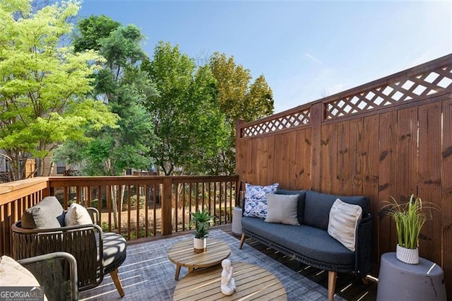 wooden terrace featuring an outdoor living space