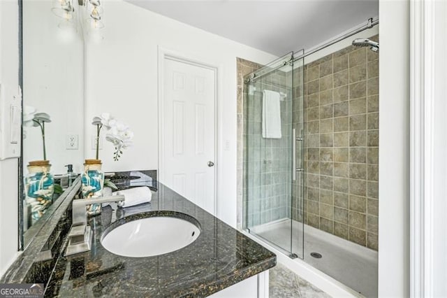 bathroom featuring vanity and a shower with shower door