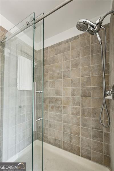 bathroom with a shower with door