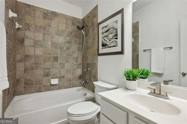 full bathroom featuring vanity, tiled shower / bath combo, and toilet