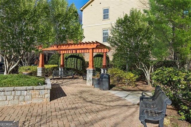 view of home's community featuring a pergola and a patio