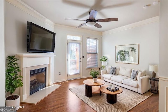 living room featuring ornamental molding, dark hardwood / wood-style floors, and ceiling fan