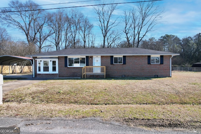 ranch-style house with a carport and a front lawn