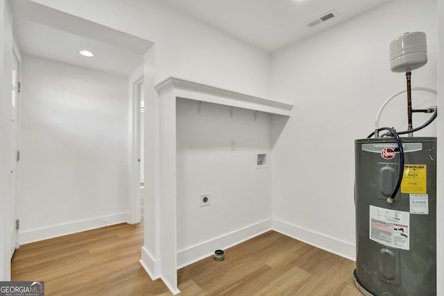 washroom featuring washer hookup, electric dryer hookup, hardwood / wood-style flooring, and water heater