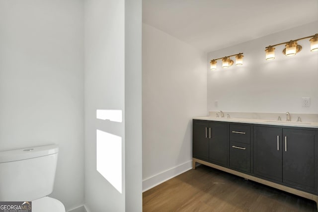 bathroom featuring vanity, hardwood / wood-style floors, and toilet