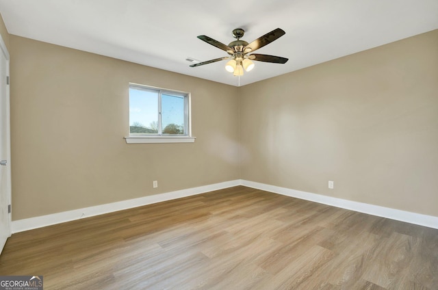 empty room with ceiling fan and light hardwood / wood-style floors