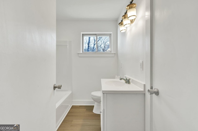 bathroom with vanity, hardwood / wood-style flooring, and toilet