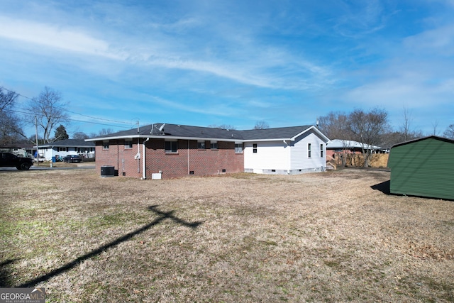 exterior space featuring a yard and central AC