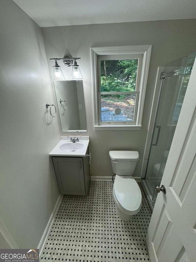 bathroom featuring vanity, toilet, and walk in shower